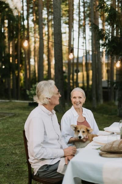 Image of a group of seniors enjoying a dinner together in the woods