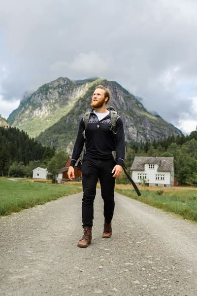 Image of person with a backpack looking away at a mountain view